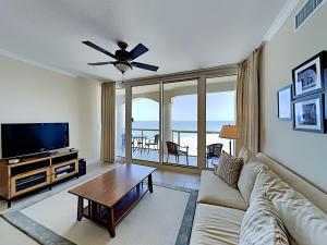 a living room with a couch and a flat screen tv at Portofino Island Resort #5-1403 in Pensacola Beach