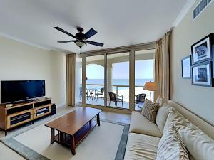 a living room with a couch and a flat screen tv at Port51403 in Pensacola Beach