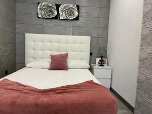 a bedroom with a large white bed with a red blanket at Alojamento Joaninha Douro in Peso da Régua