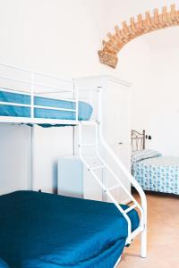 a bedroom with a bunk bed with a ladder at Agriturismo Irghitula in Posada