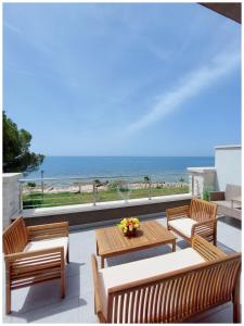 a patio with a table and chairs and the beach at Villa Lucia Umag in Umag