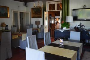 a dining room with a table and chairs and a room with at Hotel Viktória in Balatonalmádi