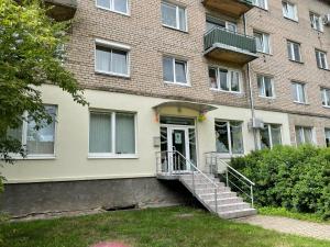 a brick building with stairs leading to the front door at Apartment Danes 35 in Klaipėda