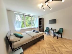 a bedroom with a bed and a table and chairs at Apartament 21 in Gdynia