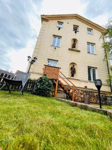 a house with a man in the window of it at Apartmá Luxura in Děčín