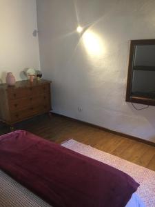 a bedroom with a bed and a dresser in a room at Casa Janeiro Alentejo in Portalegre