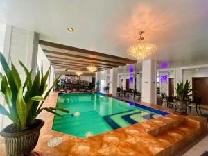 a swimming pool in the middle of a house at Bergamo Hotel in Lingayen