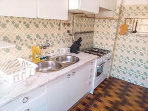 a kitchen with a sink and a stove at Enjoy Braga Estação - Charming Bedrooms in the Historic Center in Braga