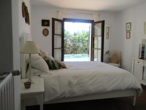 a bedroom with a large bed with a window at Casa Laibon in Gaucín