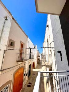 a view of an alley between two buildings at Apulia Holidays in Mola di Bari +42 photos