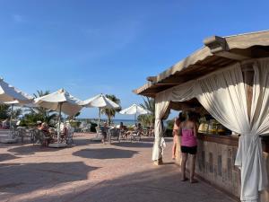 a group of people standing in front of a food stand at Dream Lagoon Resort & Aqua Park in Marsa Alam City