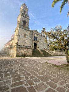 an old stone building with a clock tower on it at Hotel Terra Bella in Guadalupe