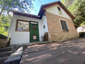 a house with a green door on a street at Rustic Cottage & Garden Retreat on Buda Hilltop in Budapest