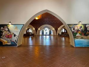 an archway in a building with paintings on the walls at Dream Lagoon Resort & Aqua Park in Marsa Alam City