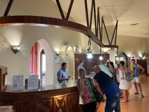 a group of people standing around a bar in a restaurant at Dream Lagoon Resort & Aqua Park in Marsa Alam City