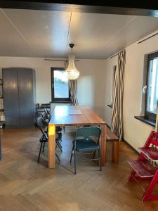 a dining room with a wooden table and chairs at Beautiful big house with garden in Tübingen