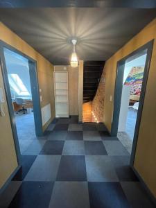 a hallway with a room with a checkered floor at Beautiful big house with garden in Tübingen
