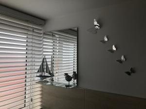 a room with a window with butterflies on the wall at Smith's Loft in Chichester