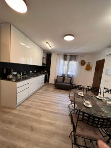 a kitchen and living room with a table and chairs at Orihuela Costa 3 bdr condo on La Zenia beach with patio in Orihuela