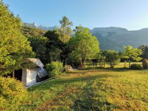 a campsite with a van parked in a field at Glamping Narnia in Bovec