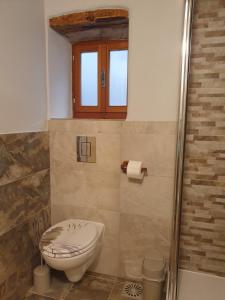a bathroom with a toilet and a window at House Tuna in Ustrine +28 photos