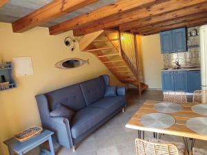 a living room with a couch and a table at House Tuna in Ustrine