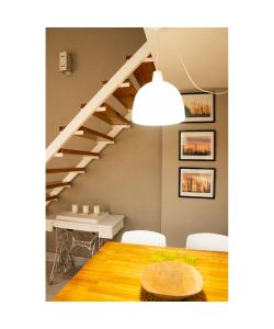 a dining room with a table and a staircase at LAS ORQUIDEAS in Plottier