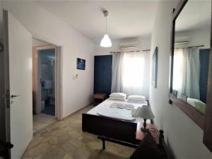 a bedroom with a bed and a mirror in it at Elli Studios & Apartments in Marathokampos
