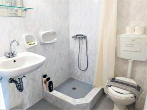 a bathroom with a shower and a toilet and a sink at Elli Studios & Apartments in Marathokampos