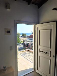 an open door with a view of a patio at Elli Studios & Apartments in Marathokampos