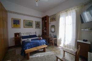 a bedroom with a blue bed and a window at Casa Franz in Tropea