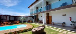 an exterior view of a house with a swimming pool at Pousada e Casas João e Ana in Barra Grande