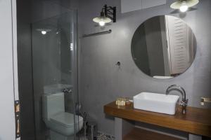 a bathroom with a toilet and a sink and a mirror at Elia Daliani in Chania Town