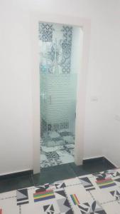 een badkamer met een douche en een glazen deur bij FAVORITE COMFORT in Beer Sheva