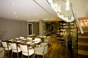 a restaurant with a long table and chairs at The Belgrave Hotel in London