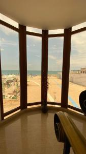 a room with a large window with a view of a field at Sor Inn Holiday in Eforie Nord
