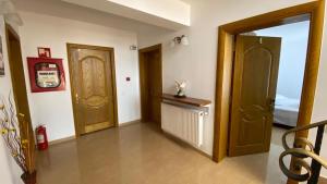 a hallway with two doors and a room with a bed at Sor Inn Holiday in Eforie Nord