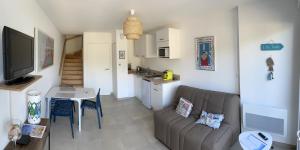 a living room with a couch and a table at Résidence l’Esprit de la mer in Combrit