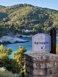 a sign for thespica river with a mountain in the background at Villetta Roberto Le Macine di Charme - Pugnochiuso Resort in Vieste