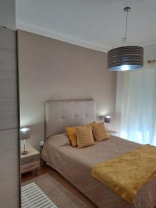 a bedroom with a bed with two pillows on it at Beja Garden apartamento com terraço privado in Beja