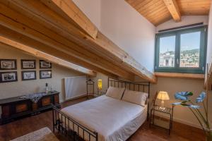 a bedroom with a bed and a large window at Palazzo Salem M1 Roof Garden in Trieste