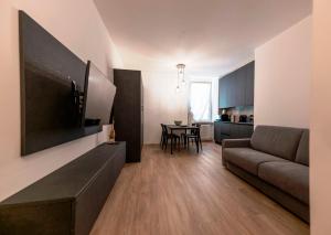 a living room with a couch and a table at San Rocco Apartments in Riva del Garda