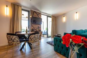 a living room with a green couch and a table at Mrak Zadar Exclusive in Zadar