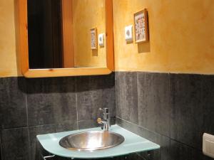 a bathroom with a sink and a mirror at Olles Apartment in Barcelona