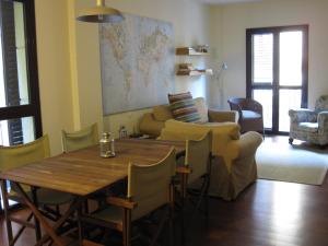 a living room with a table and a couch at Olles Apartment in Barcelona