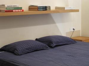 two pillows sitting on a bed in a bedroom at Olles Apartment in Barcelona