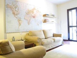a living room with a couch and a map on the wall at Olles Apartment in Barcelona