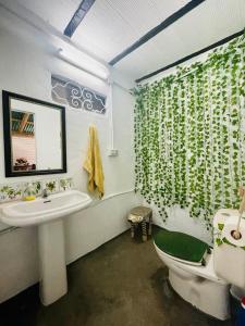 a bathroom with a sink and a toilet and a mirror at Casa Rural las Tres Rosas in Gaucín