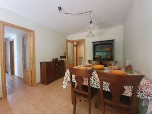 a kitchen with a table with chairs and a dining room at Apartamento Naturaleza 2000 Jaca 1º in Jaca