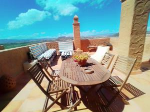 a wooden table and chairs on a balcony at Apartamento Mojacar Playa in Mojácar